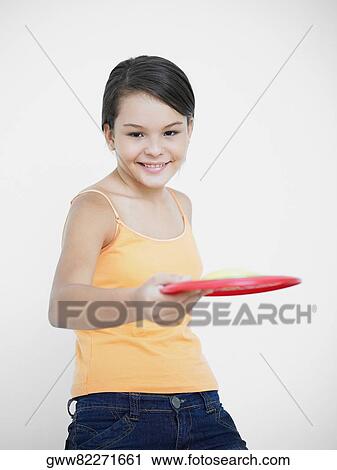 Portrait of a teenage girl playing with a plastic disc View Large Photo Image Stock Image - Portrait of a teenage girl playing with a plastic disc. Fotosearch