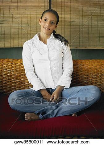 Stock Image - Portrait of a teenage girl sitting on a couch. Fotosearch