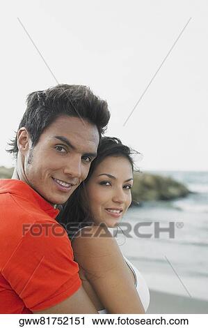 Portrait of a young man embracing a young woman View Large Photo Image Stock Image - Portrait of a young man embracing a young woman. Fotosearch
