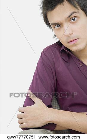 Portrait of a young man looking serious View Large Photo Image Stock Image - Portrait of a young man looking serious. Fotosearch