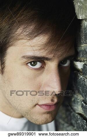 Portrait of a young man looking serious View Large Photo Image Stock Image - Portrait of a young man looking serious. Fotosearch