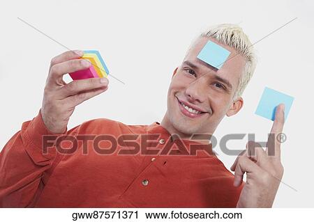 Portrait of a young man smiling with adhesive notes View Large Photo Image Stock Image - Portrait of a young man smiling with adhesive notes. Fotosearch