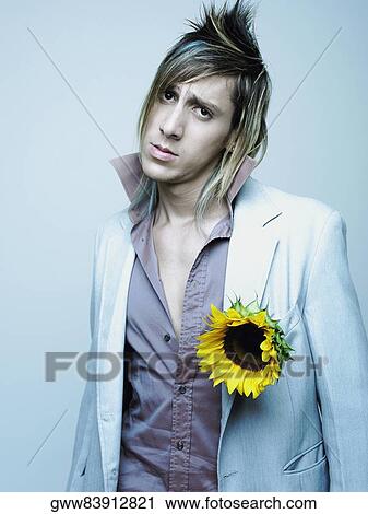 Portrait of a young man wearing a sunflower on his coat (Helianthus annuus) View Large Photo Image Stock Image - Portrait of a young man wearing a sunflower on his coat (Helianthus annuus). Fotosearch