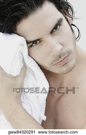 Portrait of a young man wiping his face with a towel View Large Photo Image Stock Image - Portrait of a young man wiping his face with a towel. Fotosearch