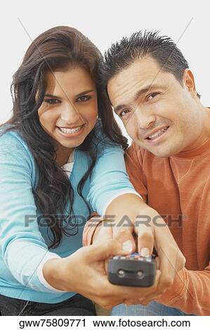 Portrait of a young woman and a mid adult man operating a remote control View Large Photo Image Stock Image - Portrait of a young woman and a mid adult man operating a remote control. Fotosearch