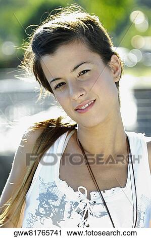 Portrait of a young woman leaning against a railing View Large Photo Image Stock Image - Portrait of a young woman leaning against a railing. Fotosearch