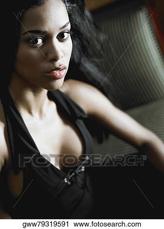 Portrait of a young woman looking serious View Large Photo Image Stock Image - Portrait of a young woman looking serious. Fotosearch
