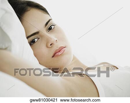 Portrait of a young woman lying on her back View Large Photo Image Stock Image - Portrait of a young woman lying on her back. Fotosearch