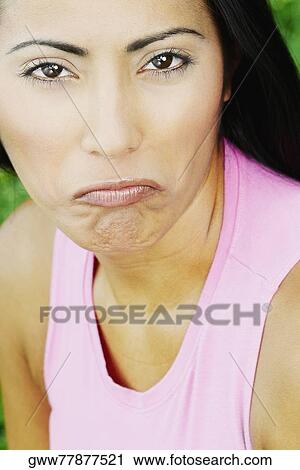 Portrait of a young woman making a face View Large Photo Image Stock Image - Portrait of a young woman making a face. Fotosearch