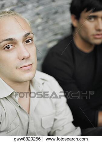 Portrait of two young men sitting together View Large Photo Image Stock Image - Portrait of two young men sitting together. Fotosearch