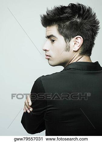 Rear view of a young man looking sideways View Large Photo Image Stock Image - Rear view of a young man looking sideways. Fotosearch