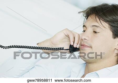 Side profile of a businessman using a telephone View Large Photo Image Stock Image - Side profile of a businessman using a telephone. Fotosearch