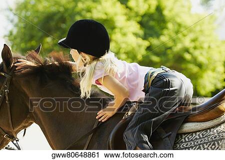 Side profile of a girl horseback riding View Large Photo Image Stock Image - Side profile of a girl horseback riding. Fotosearch