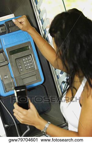 Side profile of a mid adult woman hitting a payphone with her hand View Large Photo Image Stock Image - Side profile of a mid adult woman hitting a payphone with her hand. Fotosearch
