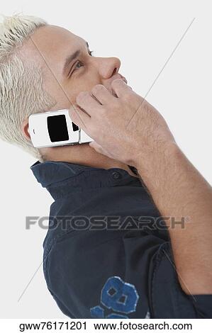 Side profile of a young man using a mobile phone View Large Photo Image Stock Image - Side profile of a young man using a mobile phone. Fotosearch