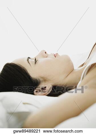 Side profile of a young woman lying on her back View Large Photo Image Stock Image - Side profile of a young woman lying on her back. Fotosearch