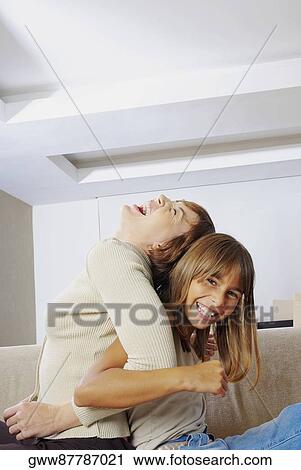 Side profile of a young woman playing with her daughter View Large Photo Image Stock Image - Side profile of a young woman playing with her daughter. Fotosearch