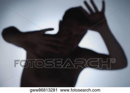 Silhouette of a man shielding his face with his arms View Large Photo Image Stock Image - Silhouette of a man shielding his face with his arms . Fotosearch