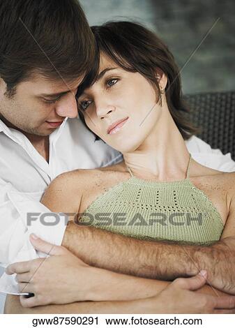 Young man embracing a young woman from behind View Large Photo Image Stock Image - Young man embracing a young woman from behind. Fotosearch