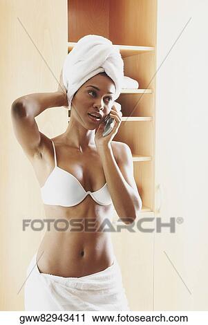 Young woman talking on a mobile phone View Large Photo Image Stock Image - Young woman talking on a mobile phone. Fotosearch