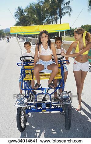 Young woman walking and her three friends in a buggy View Large Photo Image Stock Image - Young woman walking and her three friends in a buggy. Fotosearch