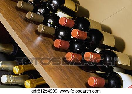 Alcoholic bottles on shelves View Large Photo Image Stock Photo - Alcoholic bottles on shelves. Fotosearch