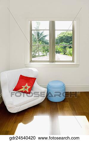 Armchair and an ottoman in a living room View Large Photo Image Stock Image - Armchair and an ottoman in a living room. Fotosearch