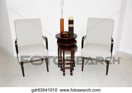 Armchairs with stool in a living room View Large Photo Image Stock Image - Armchairs with stool in a living room. Fotosearch