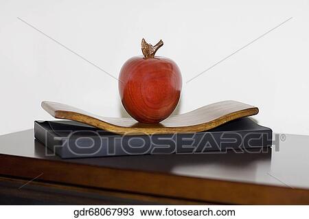Stock Image - Artificial apple on a table. Fotosearch