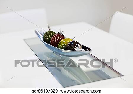 Stock Photo - Artificial fruits in a bowl on a dining table. Fotosearch