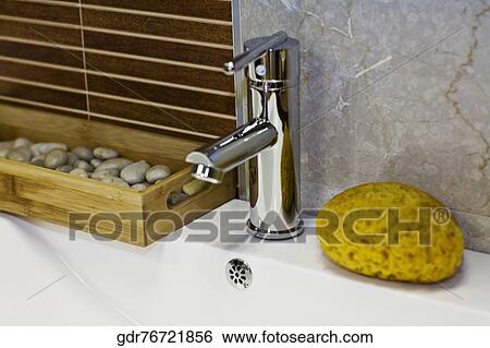 Bath sponge near a faucet on a wash bowl View Large Photo Image Stock Photograph - Bath sponge near a faucet on a wash bowl. Fotosearch