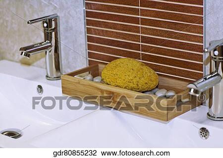 Bath sponge near faucets on a wash bowl View Large Photo Image Stock Image - Bath sponge near faucets on a wash bowl. Fotosearch