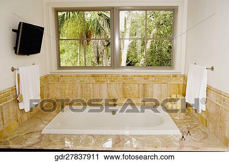 Stock Image - Bathtub in a bathroom. Fotosearch