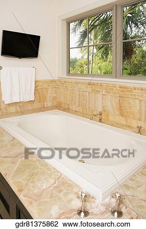 Stock Image - Bathtub in a bathroom. Fotosearch