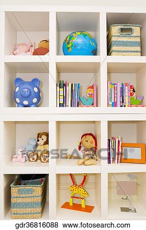 Books and toys on a shelf View Large Photo Image Stock Photo - Books and toys on a shelf. Fotosearch
