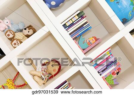 Books and toys on a shelf View Large Photo Image Stock Photo - Books and toys on a shelf. Fotosearch