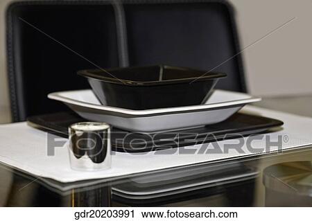 Bowl and a tray on a dining table View Large Photo Image Stock Image - Bowl and a tray on a dining table. Fotosearch