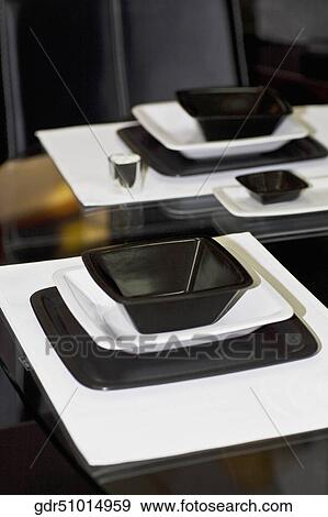 Bowl and a tray on a dining table View Large Photo Image Stock Photo - Bowl and a tray on a dining table. Fotosearch