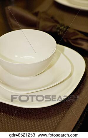 Bowl and plates on a dining table View Large Photo Image Stock Image - Bowl and plates on a dining table. Fotosearch