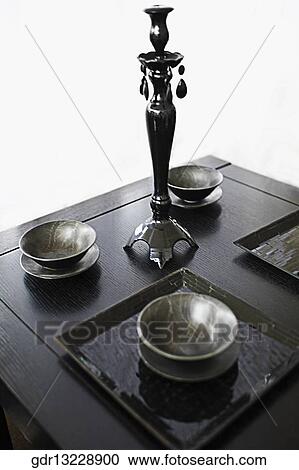Bowls and a showpiece on a table View Large Photo Image Stock Image - Bowls and a showpiece on a table. Fotosearch