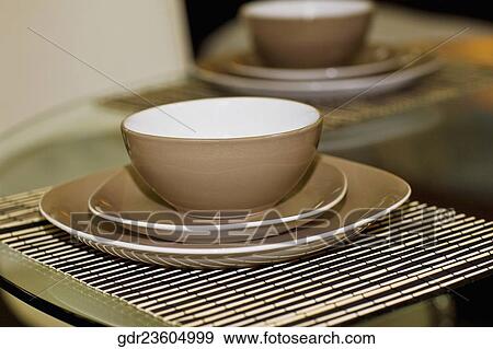 Bowls and plates on a dining table View Large Photo Image Stock Photo - Bowls and plates on a dining table. Fotosearch