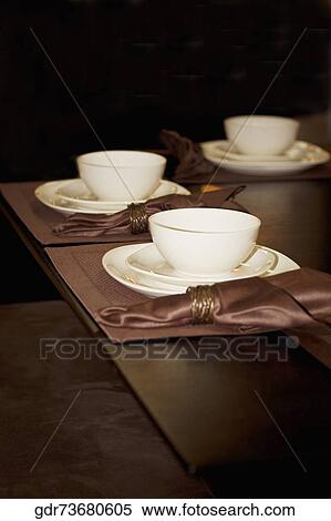 Bowls and plates on a dining table View Large Photo Image Stock Photography - Bowls and plates on a dining table. Fotosearch