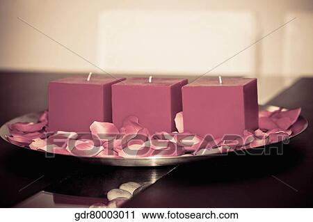 Candles and rose petals in a plate on a table View Large Photo Image Stock Image - Candles and rose petals in a plate on a table. Fotosearch