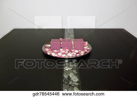 Candles and rose petals in a plate on a table View Large Photo Image Stock Photograph - Candles and rose petals in a plate on a table. Fotosearch