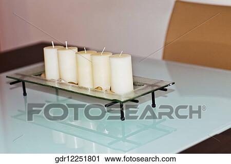 Stock Image - Candles in a candle stand. Fotosearch