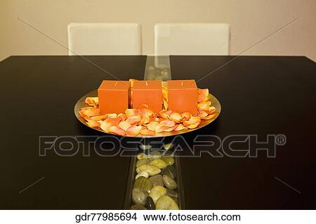 Picture - Candles in a plate on a dining table. Fotosearch