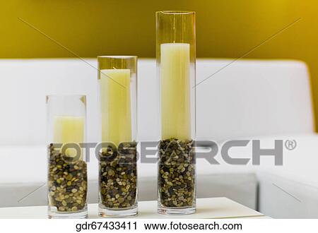 Candles in candlestick holders on a table View Large Photo Image Stock Image - Candles in candlestick holders on a table. Fotosearch