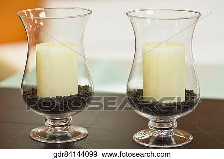 Candles in candlestick holders on a table View Large Photo Image Stock Photo - Candles in candlestick holders on a table. Fotosearch