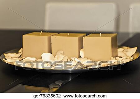 Candles with rose petals on a plate View Large Photo Image Stock Image - Candles with rose petals on a plate. Fotosearch