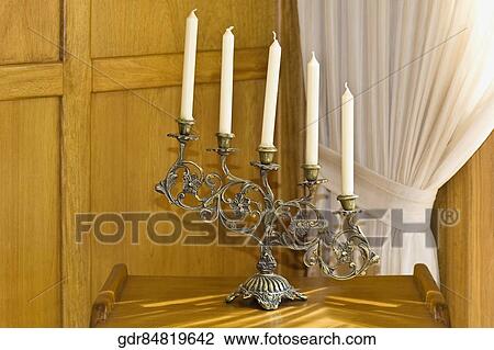 Stock Image - Candlestick holder on a stool. Fotosearch